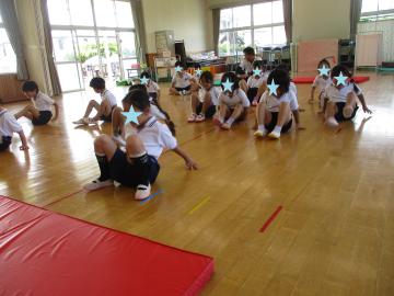 5歳児の運動遊びで、座ったまま後ろ向きに移動する様子